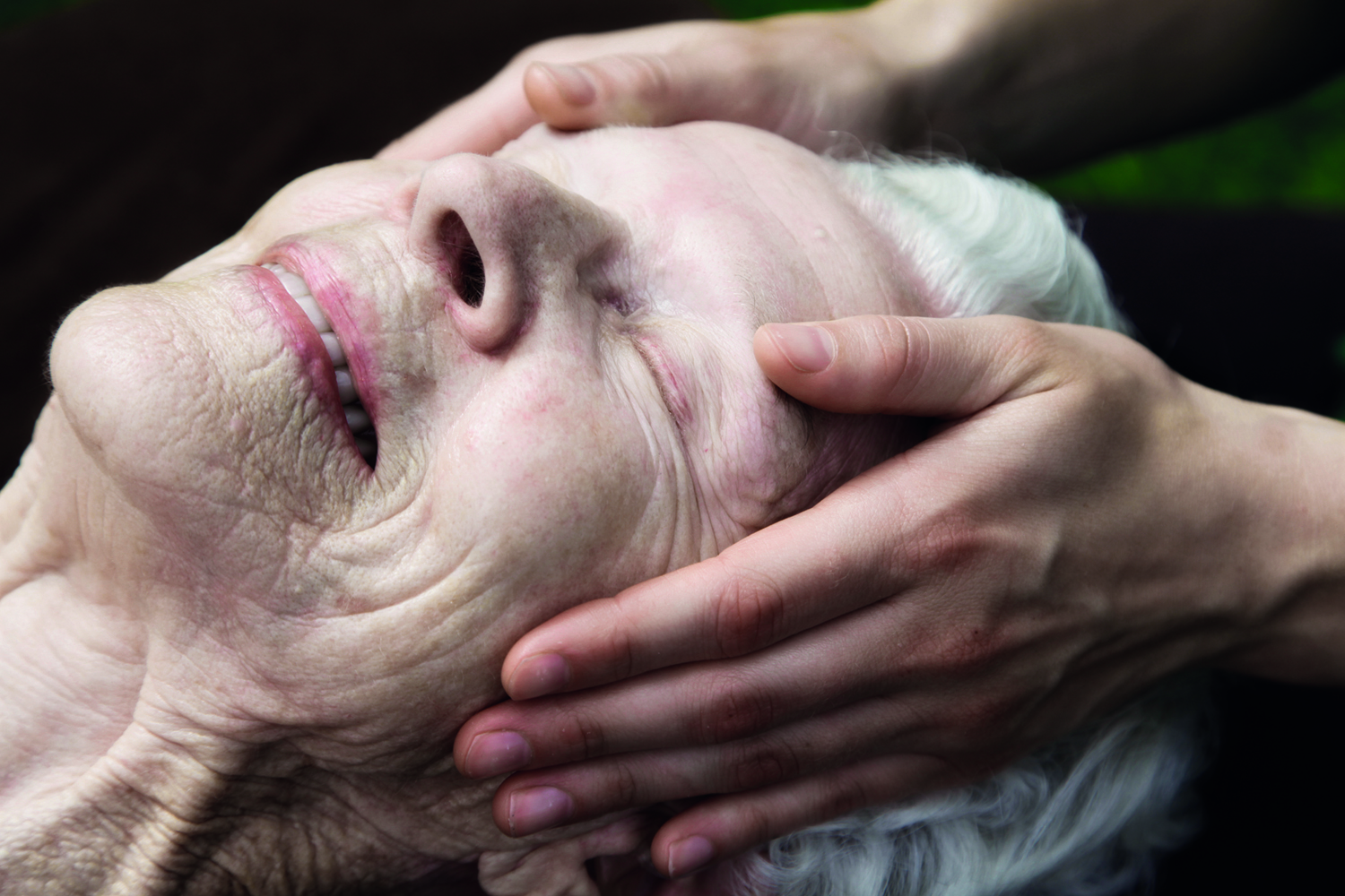 Senior client having craniosacral therapy